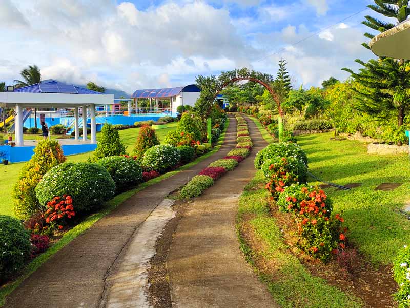 Pathway inside the resort brandished with colorful flowers and well-decorated plants.