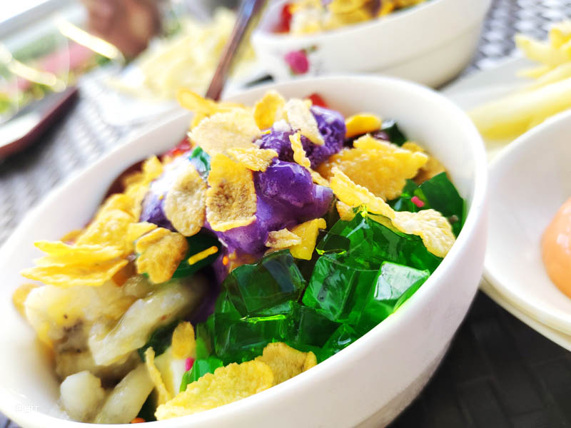 Tastiest halo-halo with cornflakes, green jelly, ube ice cream, sweetened banana, sprinkles, and many other delicious ingredients.