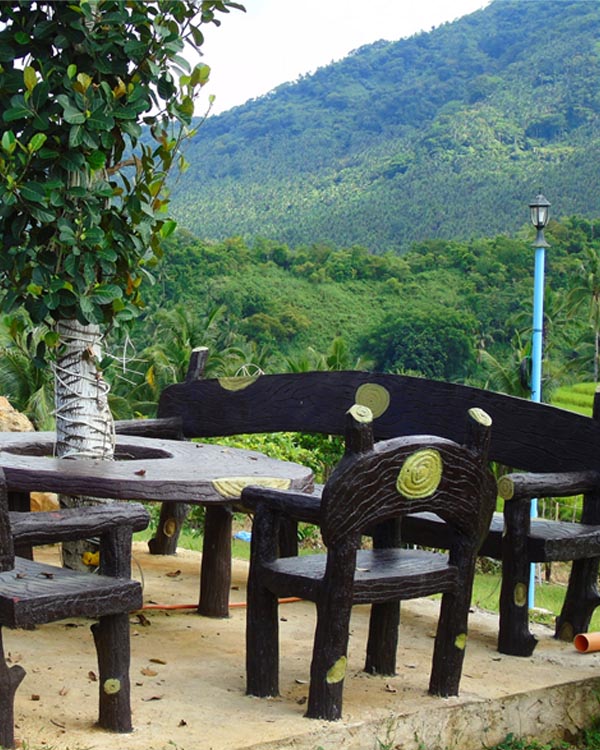 Painted benches with an overview of the mountains.