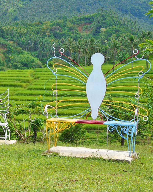 A metal bench decorated designed as a butterfly.