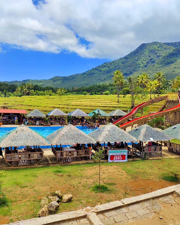 The Pool, cottages, and lush mountains behind the park.
