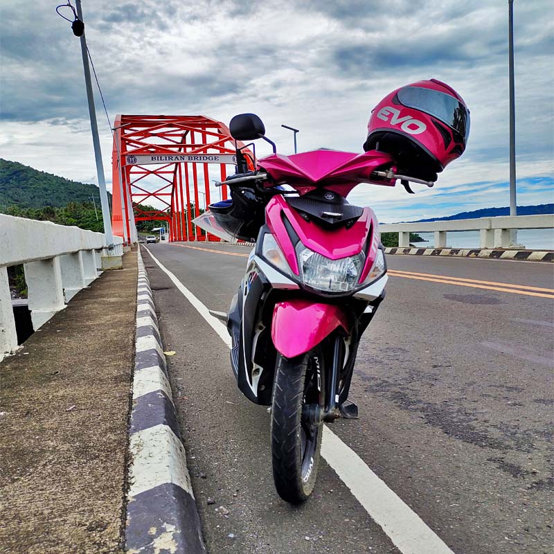 A Rider take a photo of her Motorcycle in the iconic Biliran Bridge.