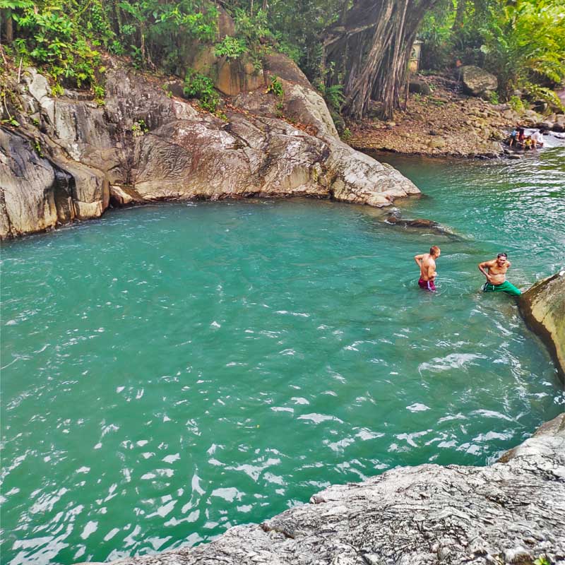 Visitors enjoying the cold water of Tinago Falls.