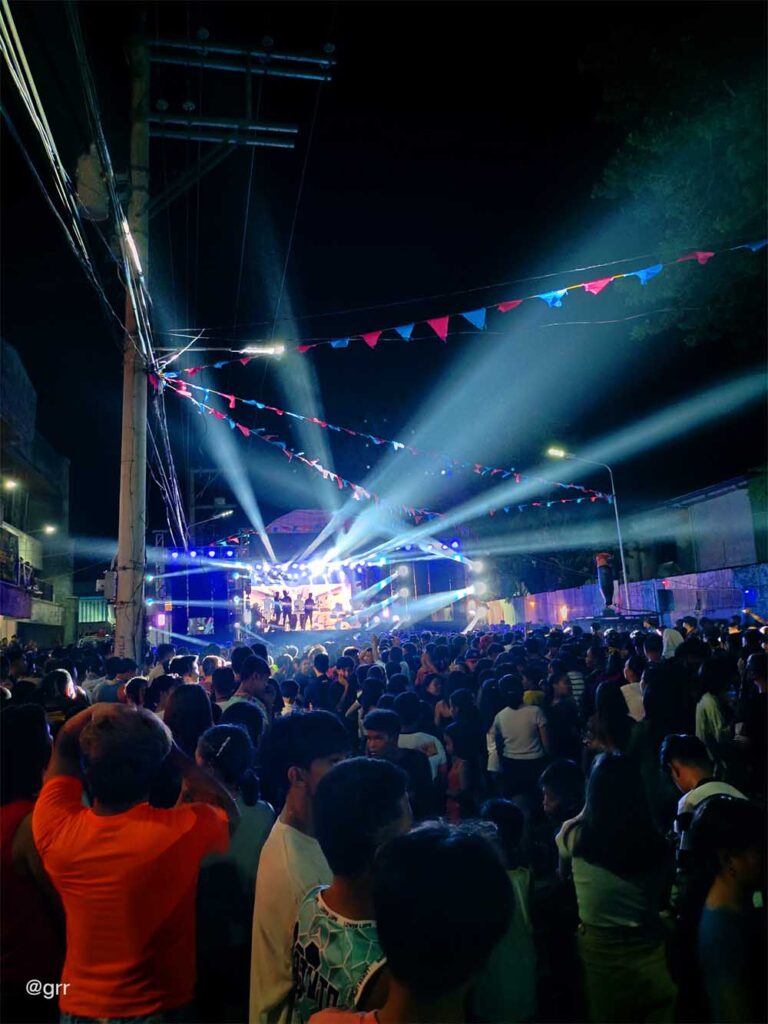 Crowd watching the stage at a distance.
