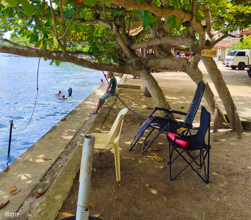Portable chairs placed under the talisay tree.